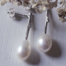 Load image into Gallery viewer, Pearl_drop_earrings-oval_white_pearls on white background with dried white fowers