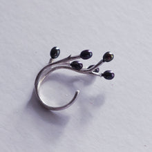 Load image into Gallery viewer, adjustable twig ring black peacock pearls placed on the the side with white background