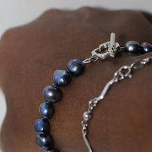 Load image into Gallery viewer, Knotted pearl bracelet worn, closer shot on black woman hand