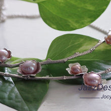 Load image into Gallery viewer, Statement necklace, pearl flowers and twigs necklace, close-up shot of the central piece of the collar, placed on green leaves on a white background