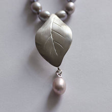 Load image into Gallery viewer, Close-up shot on leaf pendant, face on, grey pearls knot necklace, leaf silver pendant necklace.