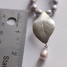 Load image into Gallery viewer, Grey pearls knot necklace, leaf silver pendant necklace place near a ruler