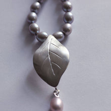 Load image into Gallery viewer, Grey pearls knot necklace - close-up shot on the leaf silver pendant