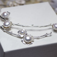Load image into Gallery viewer, Statement necklace, pearl flowers and twigs necklace, close-up shot of the central piece of the collar, white pearls, placed on white box