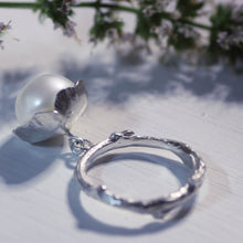 Load image into Gallery viewer, Pearl charm, flower ring placed near a branch with tiny flowers