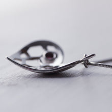 Load image into Gallery viewer, Sterling silver heart pendant with a red garnet cabochon, face down, profile shot on white background