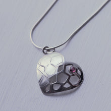 Load image into Gallery viewer, Sterling silver heart pendant with a red garnet cabochon, white background