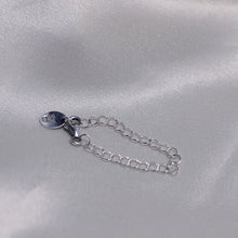 Load image into Gallery viewer, Silver chain extender placed on  white satin backdrop
