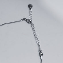 Load image into Gallery viewer, Silver chain extender placed to lengthen necklace
