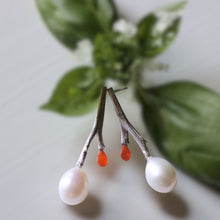 Load image into Gallery viewer, Silver twig earrings, white oval pearls and cornalian briolette, green leaves in the background
