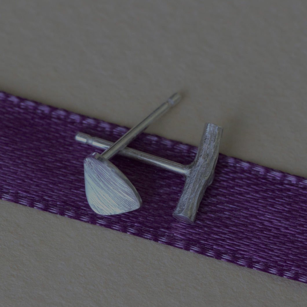 Mismatched stud earrings, silver twig and tiny leaf