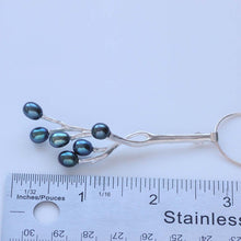 Load image into Gallery viewer, Twig pendant blue pearls placed near a ruler
