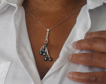 Load image into Gallery viewer, Twig pendant blue pearls worn on 24&#39;&#39; silver chain with a white shirt
