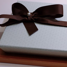 Load image into Gallery viewer, Send some love with the gift wraps options I offer, close-up on a large box, marron ribbon
