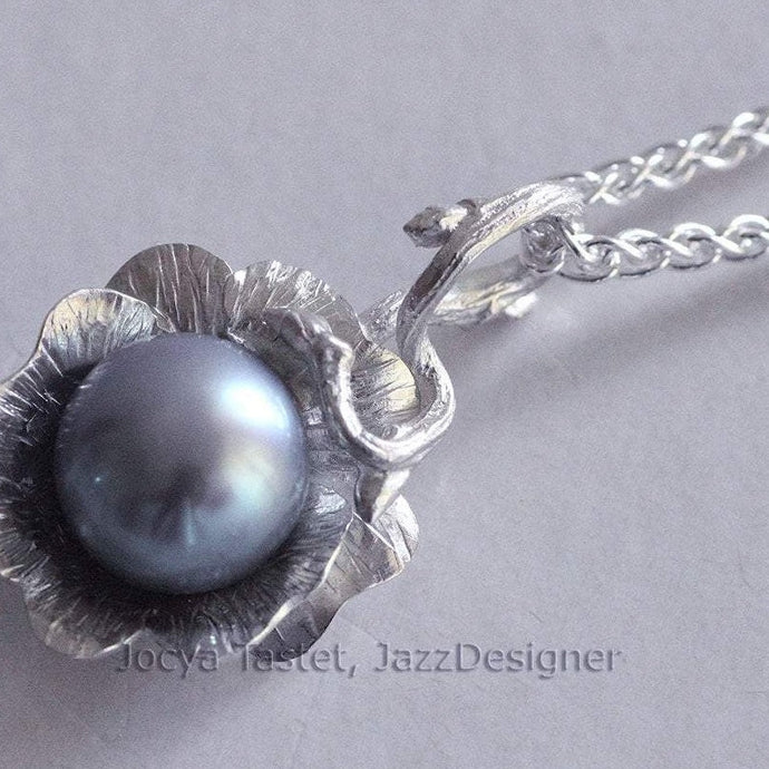 Silver flower pendant, grey pearl on white background