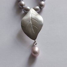 Load image into Gallery viewer, Close-up shot on leaf pendant, face on, grey pearls knot necklace, leaf silver pendant necklace.
