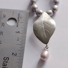 Load image into Gallery viewer, Grey pearls knot necklace, leaf silver pendant necklace place near a ruler
