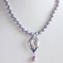 Load image into Gallery viewer, Grey pearls knot necklace, leaf silver pendant necklace placed on a jewelry  bust display
