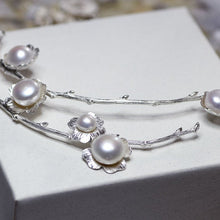 Load image into Gallery viewer, Statement necklace, pearl flowers and twigs necklace, close-up shot of the central piece of the collar, white pearls, placed on white box
