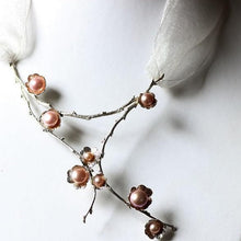 Load image into Gallery viewer, Large silver necklace, pearl flowers and twig statement necklace placed on a white jewelry display bust
