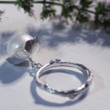 Load image into Gallery viewer, Pearl charm, flower ring placed near a branch with tiny flowers
