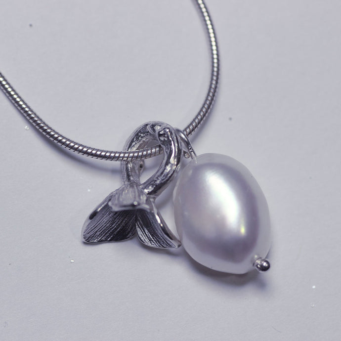 Sterling silver charm necklace, flower and pearl charms - close-up pic on charms - white background