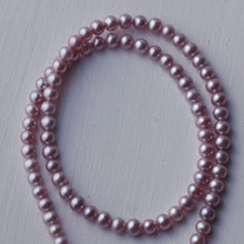 Load image into Gallery viewer, Pink pearls necklace, one strand rolled
