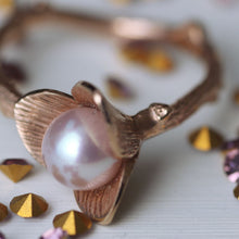 Load image into Gallery viewer, Rose gold ring, Flower pearl ring, pink pearl, twig design, close-up shot on flower, violet and gold cristals, white background
